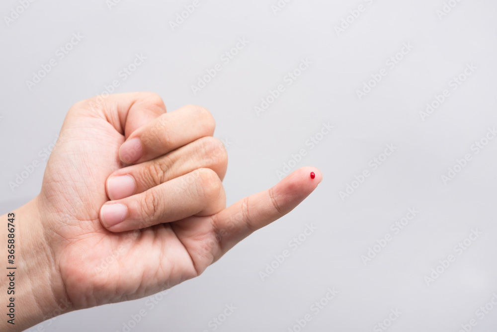 Blood drop on fingertip prepare for checking the glucose level with a glucometer for examining diabetes mellitus. Blood drop on fingertip prepare for checking the glucose level with a glucometer for examining diabetes mellitus.