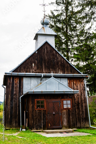 Beautiful ancient wooden greek catholic church listed on UNESCO in Beskid Niski mountain range, Poland photo