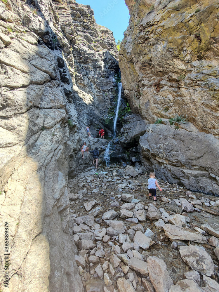 Family climbing up a waterfall Family climbing up a waterfall