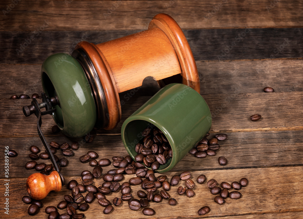 coffee grinder with coffee beans on wooden table