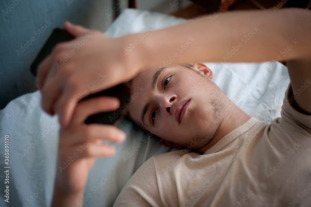 young boy wakes up in bed in the morning young boy wakes up in bed in the morning