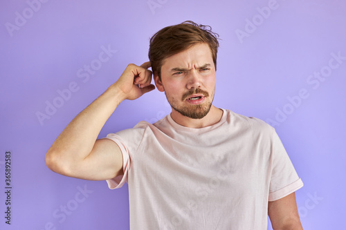 in the mans head a plan has matured, bearded young guy is in thought isolated in studio