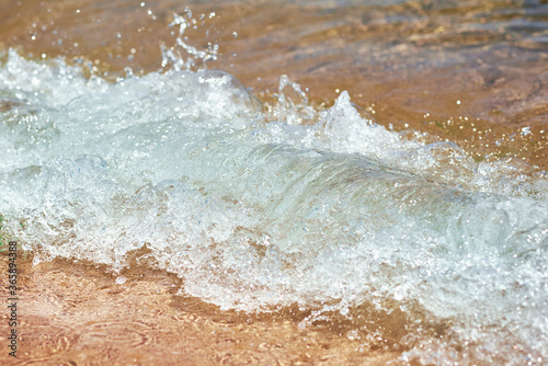 Sea wave on the sand beach, soft focus. Summer background © Lazy_Bear