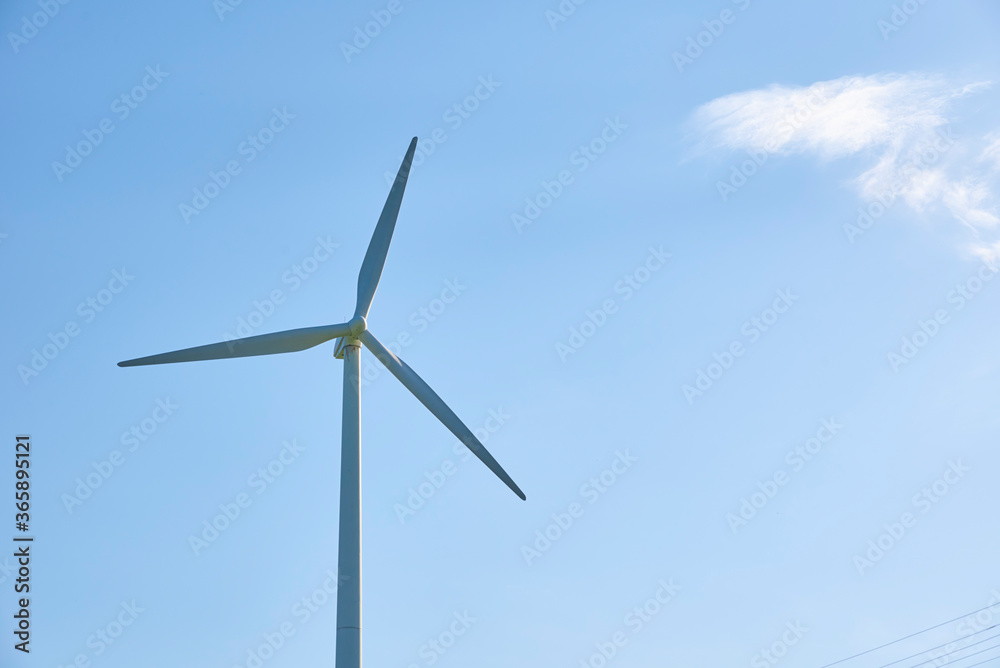 Wind turbine against blue sky. Wind power energy concept Wind turbine against blue sky. Wind power energy concept