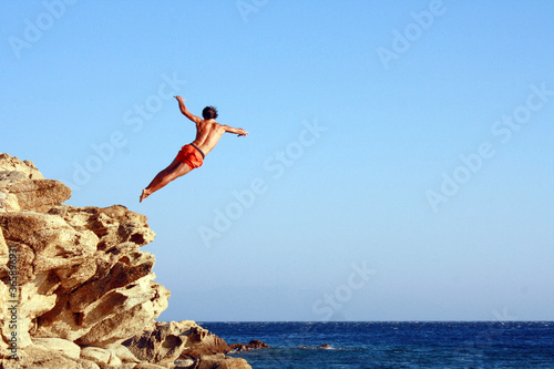men jumping on the beach