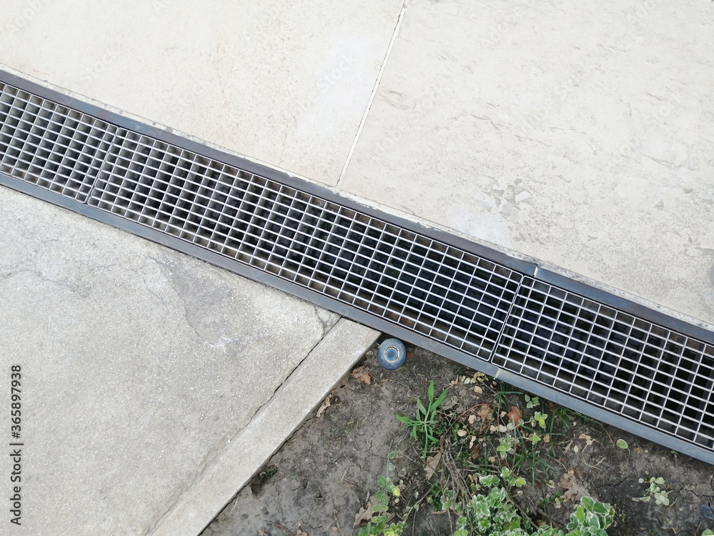 Fototapeta premium Drainage system outdoors. Metal grates for water drainage. Rain drain.