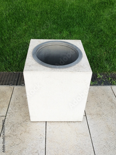 rectangular trash can in the park. garbage container on green grass. ecology, cleanliness