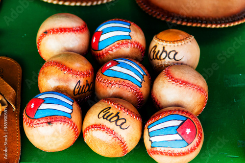 Photography Leather baseball balls and Cuban flag on the market stall