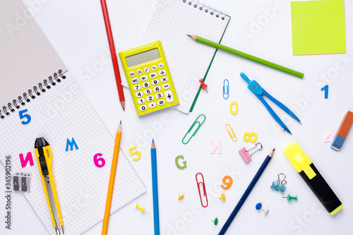 Many different school supplies on white copy space background. Back to school concept.