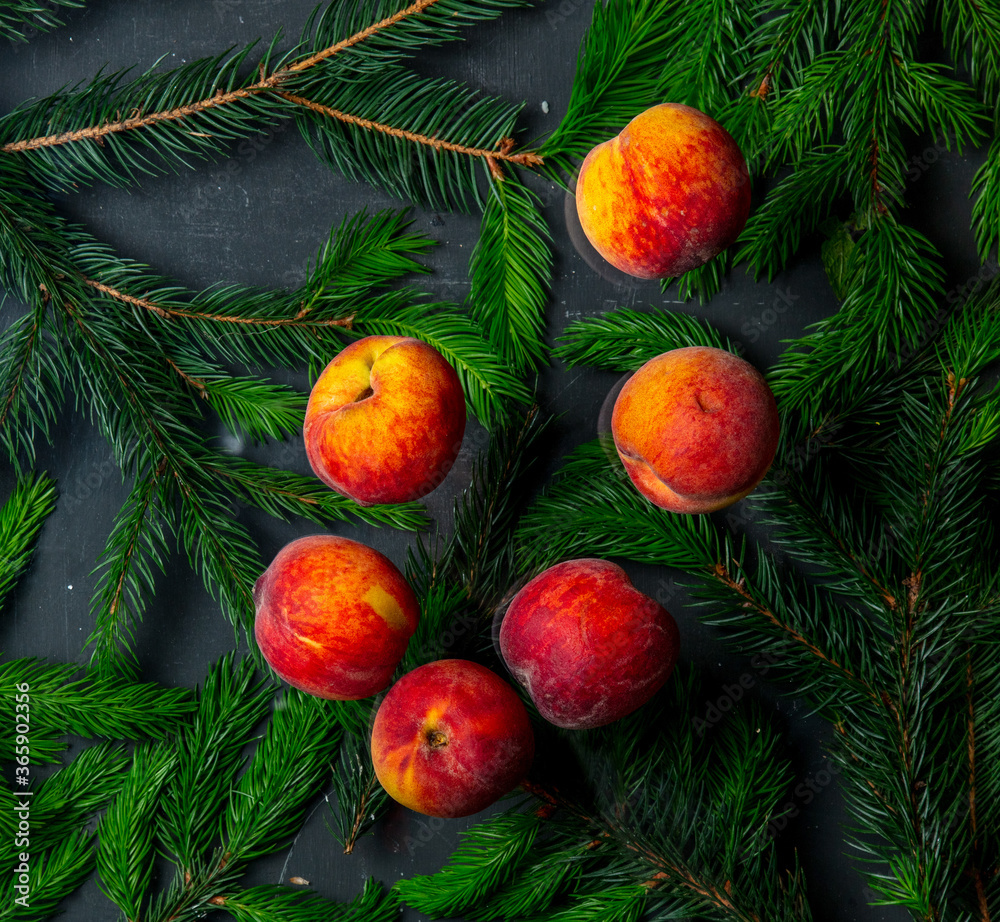 Obraz premium group of peaches with leaves and Christmas tree branches