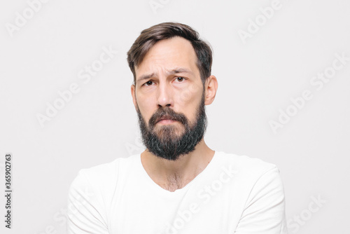  close-up portrait of sad young man in studio on white background