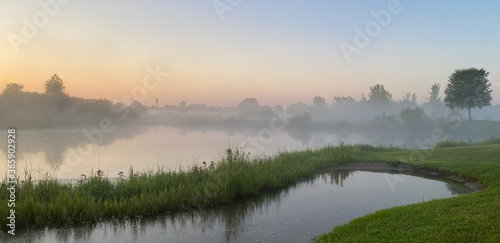 sunrise foggy morning on the golf course pond reflections