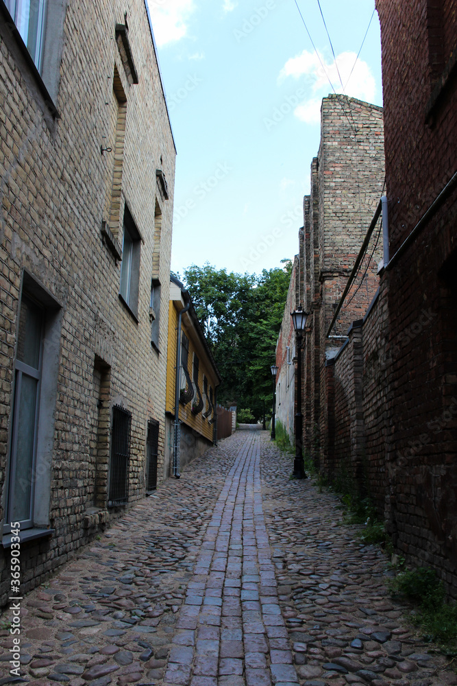 The narrow passage that goes up.  Street of the quiet center of Riga, Latvia.