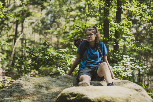 girl on an rock in a forest in blue sportsweare © Thorsten