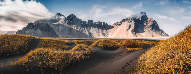 Vestrahorn mountaine on Stokksnes cape in Iceland during sunset. Amazing Iceland nature seascape. popular tourist attraction. Best famouse travel locations. Scenic Image of Iceland