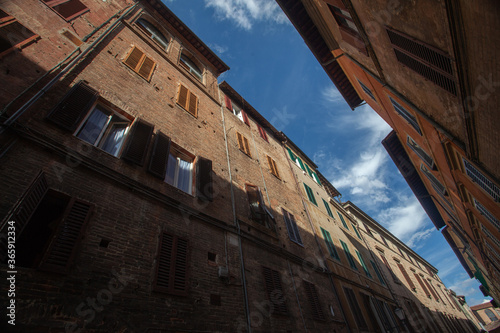 Siena, Italy - 12/09/2013: Warm colors of a street of medieval Siena Tuscany