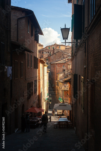 Siena, Italy - 12/09/2013: Warm colors of a street of medieval Siena Tuscany