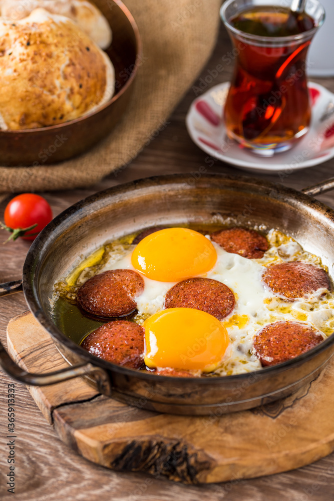 Traditional Turkish Breakfast - Fried Egg with Turkish sausage. Bread, tomato and Tea Traditional Turkish Breakfast - Fried Egg with Turkish sausage. Bread, tomato and Tea