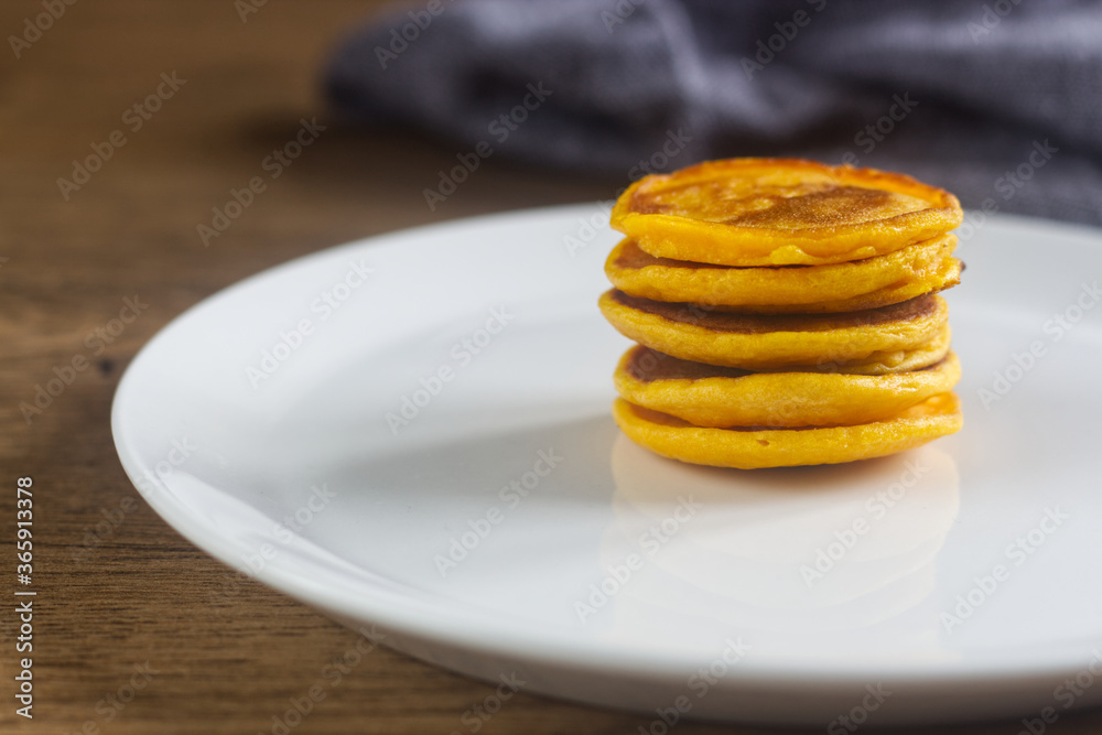 Homemade pumpkin pancakes on the white plate. Homemade pumpkin pancakes on the white plate.