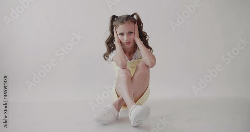 Girl with ponytails shakes her head in frustration. Desperated Girl. Isolated.