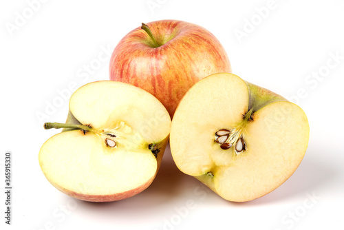 Whole and sliced red apples on white