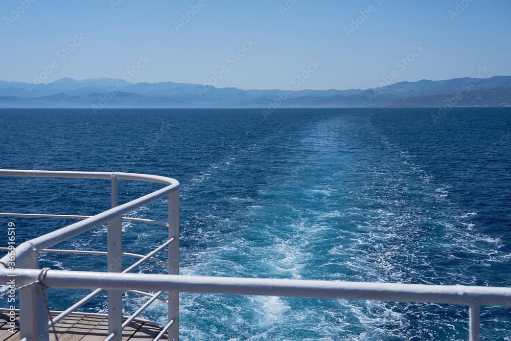 Foggy coast line of Crete, Greece. View from behind the ship. Copy space.