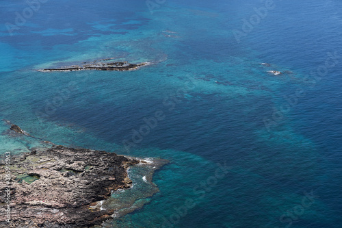 Rocky islands near Crete, Greece surrounded by blue turquoise sea water. Copy space.