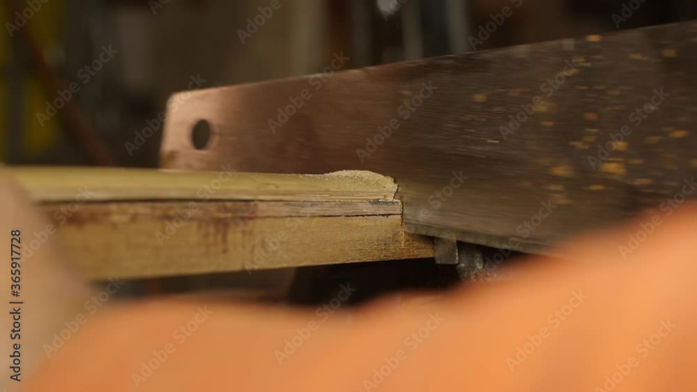 carpenter cutting wood with hand saw macro slow motion carpenter cutting wood with hand saw macro slow motion
