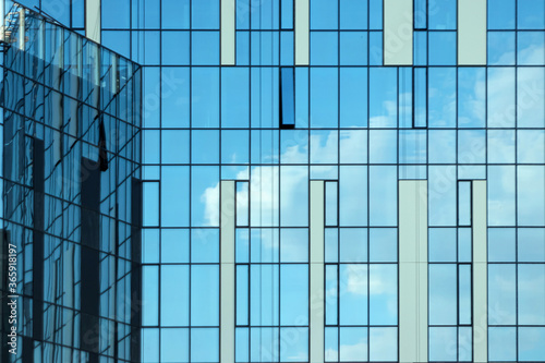 Glass office building  view of the sky reflected in the windows. Concept for work  business  offices. Copy space.