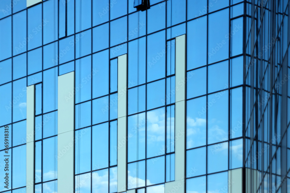 Glass office building, view of the sky reflected in the windows. Concept for work, business, offices. Copy space. Glass office building, view of the sky reflected in the windows. Concept for work, business, offices. Copy space.