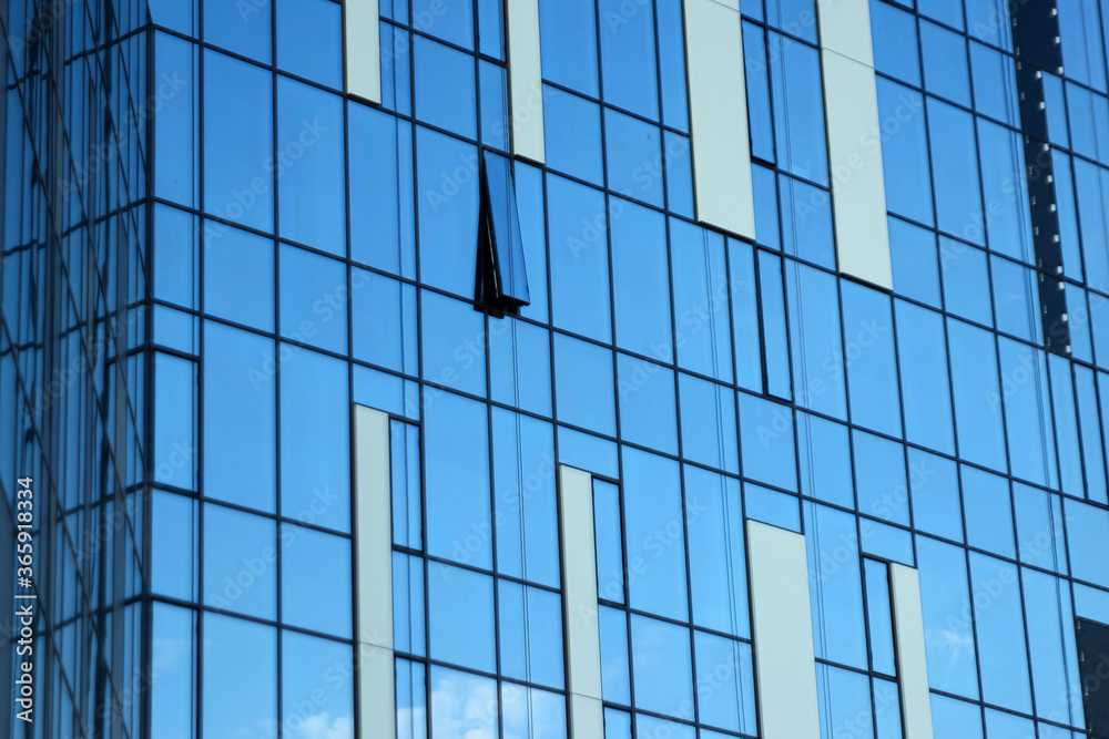 Glass office building, view of the sky reflected in the windows. Concept for work, business, offices. Copy space. Glass office building, view of the sky reflected in the windows. Concept for work, business, offices. Copy space.