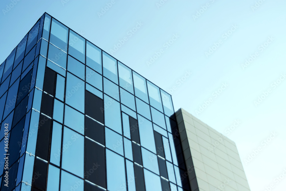 Glass office building, view of the sky reflected in the windows. Concept for work, business, offices. Copy space. Glass office building, view of the sky reflected in the windows. Concept for work, business, offices. Copy space.
