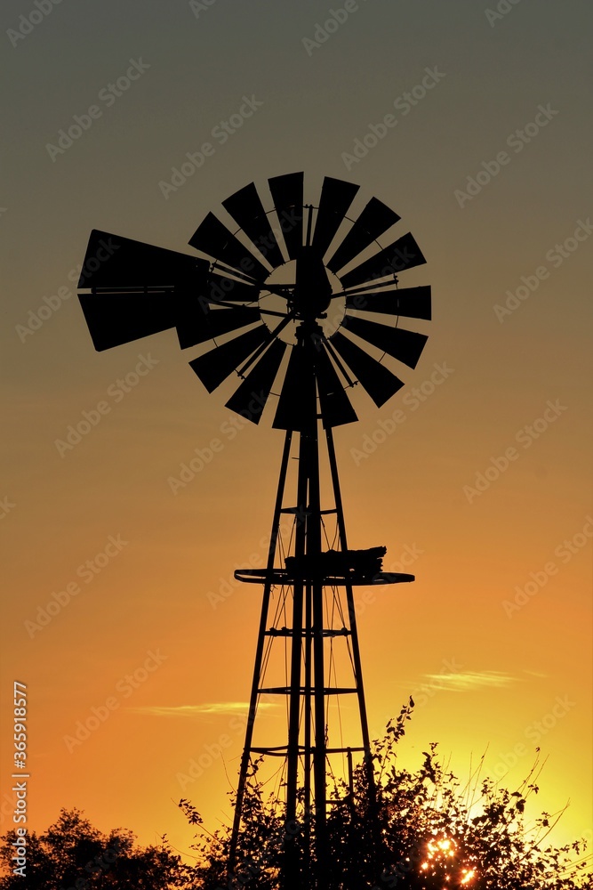 windmill at sunset with a colorful sky and clouds. windmill at sunset with a colorful sky and clouds.