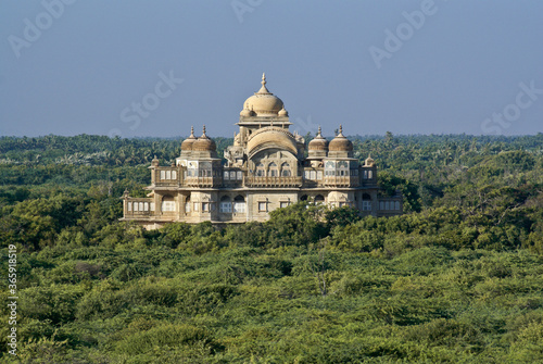 The historic Vijaya Vilas Palace sits amidst tropical vegetation near Mandvi, Gujarat, India photo