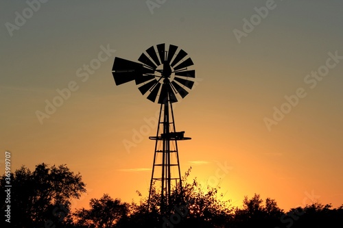 windmill at sunset with colorful clouds in Kansas
