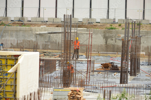 workers work on foundations on the construction site photo