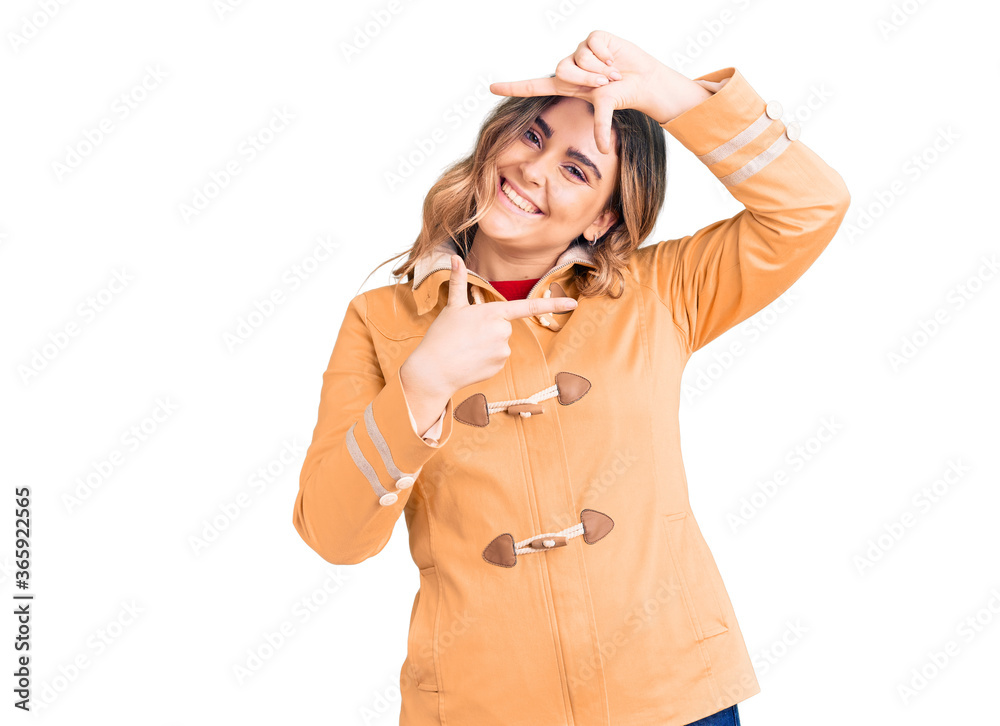 Young caucasian woman wearing casual clothes smiling making frame with hands and fingers with happy face. creativity and photography concept. Young caucasian woman wearing casual clothes smiling making frame with hands and fingers with happy face. creativity and photography concept.