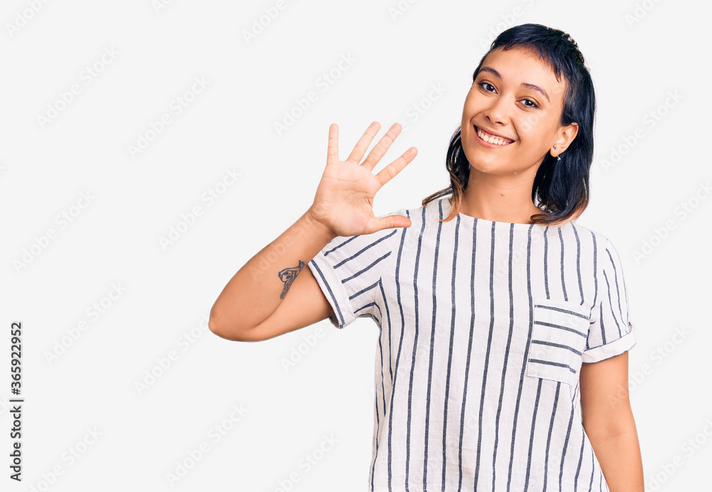 Young woman wearing casual clothes showing and pointing up with fingers number five while smiling confident and happy. Young woman wearing casual clothes showing and pointing up with fingers number five while smiling confident and happy.
