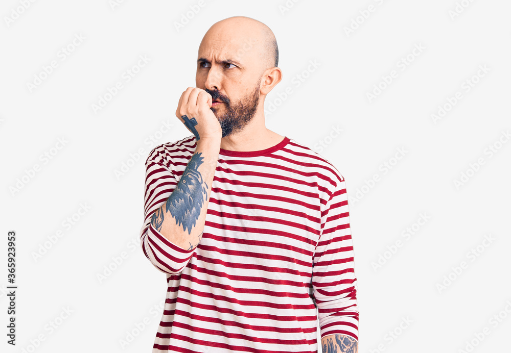 Young handsome man wearing casual clothes looking stressed and nervous with hands on mouth biting nails. anxiety problem. Young handsome man wearing casual clothes looking stressed and nervous with hands on mouth biting nails. anxiety problem.
