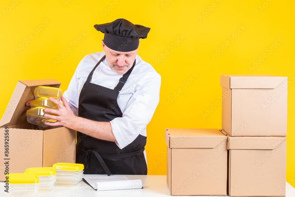 Chef checks kitchen equipment. Chef holds plastic containers