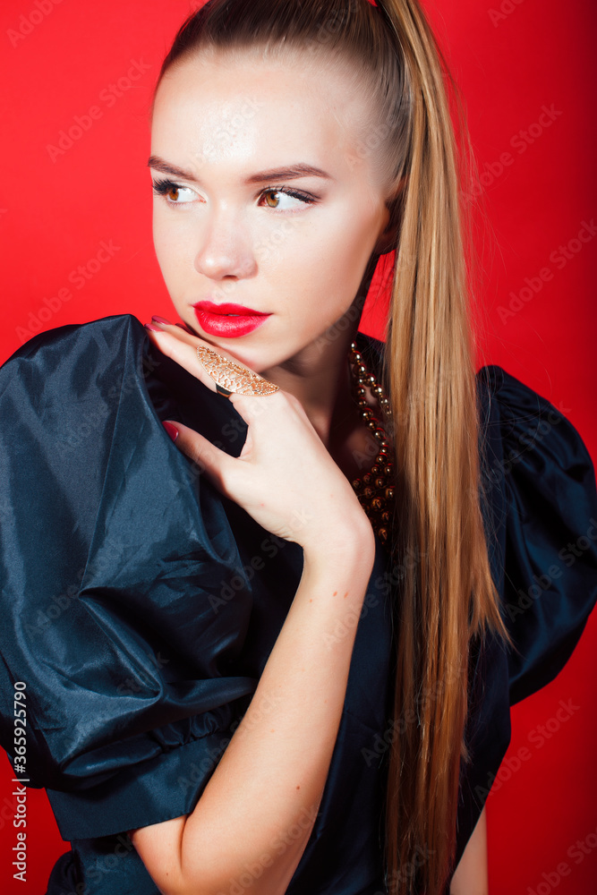 Naklejka premium young pretty woman young lady posing on red background wearing gold jewelry, lifestyle people concept
