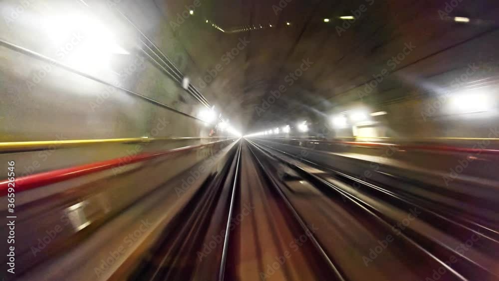 Subway metro train traveling through tunnel lit with light, point of view motion lapse Subway metro train traveling through tunnel lit with light, point of view motion lapse