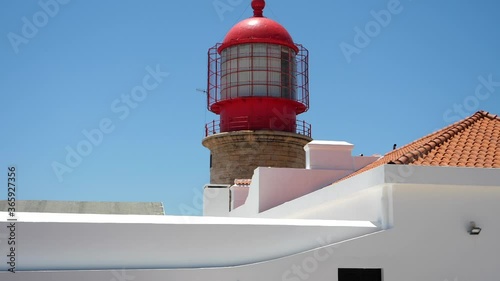 Scene with Cape of St. Vincent lighthouse on sunny day. Tilt up, slomo