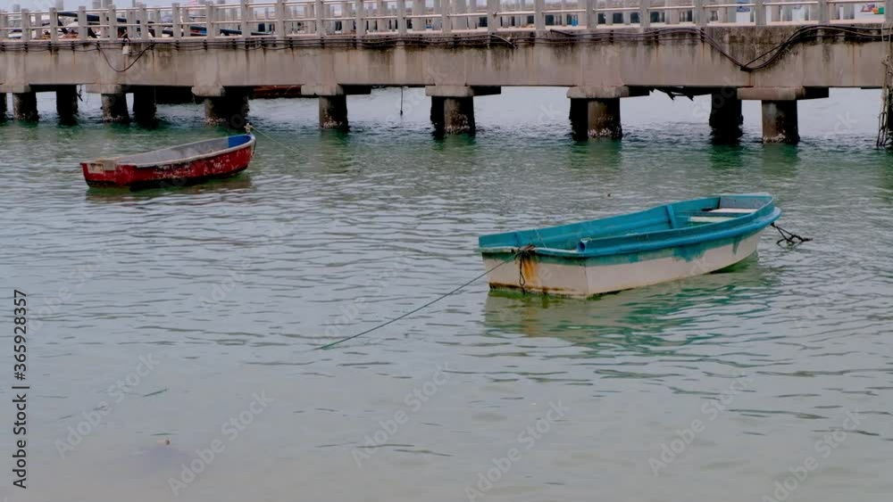 Two old row boats moored at a dock in Thailand Two old row boats moored at a dock in Thailand