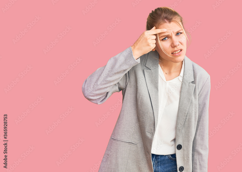 Young beautiful blonde woman wearing elegant jacket pointing unhappy to pimple on forehead, ugly infection of blackhead. acne and skin problem Young beautiful blonde woman wearing elegant jacket pointing unhappy to pimple on forehead, ugly infection of blackhead. acne and skin problem