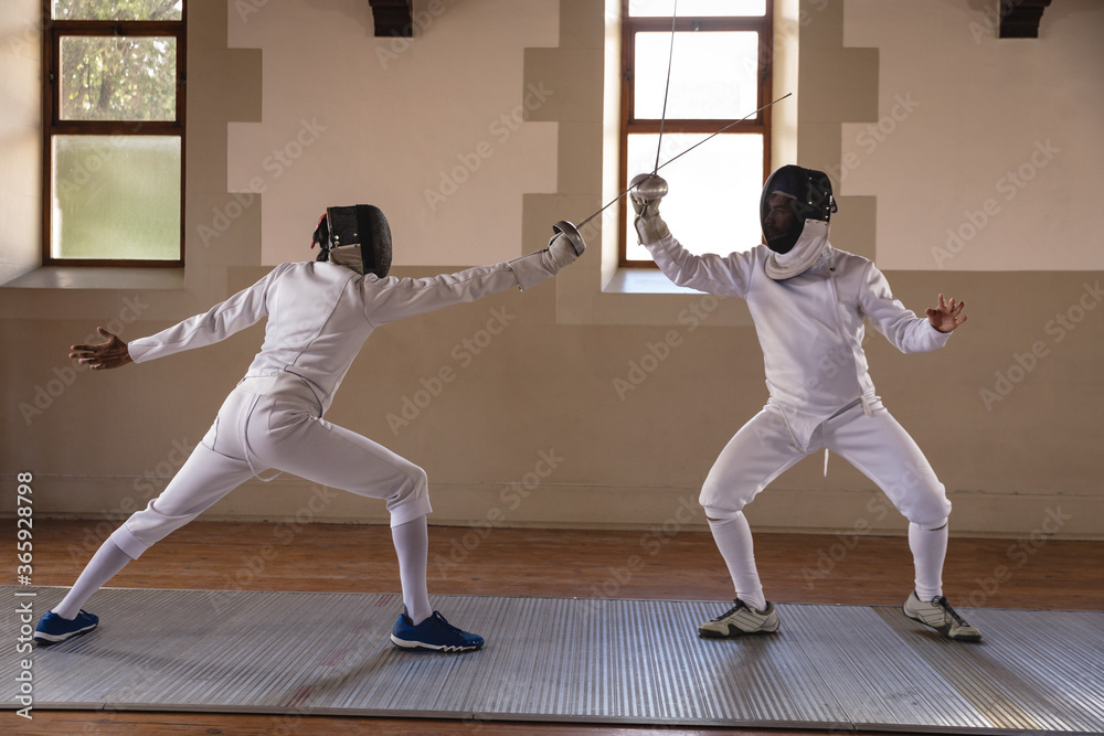 Two male fencers practicing fencing Two male fencers practicing fencing