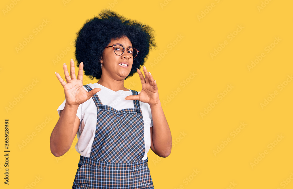 Young african american girl wearing casual clothes afraid and terrified with fear expression stop gesture with hands, shouting in shock. panic concept.