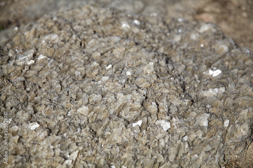 Texture of sharp small stones sparkling in the sun, with a small depth of field, background image, desktop image