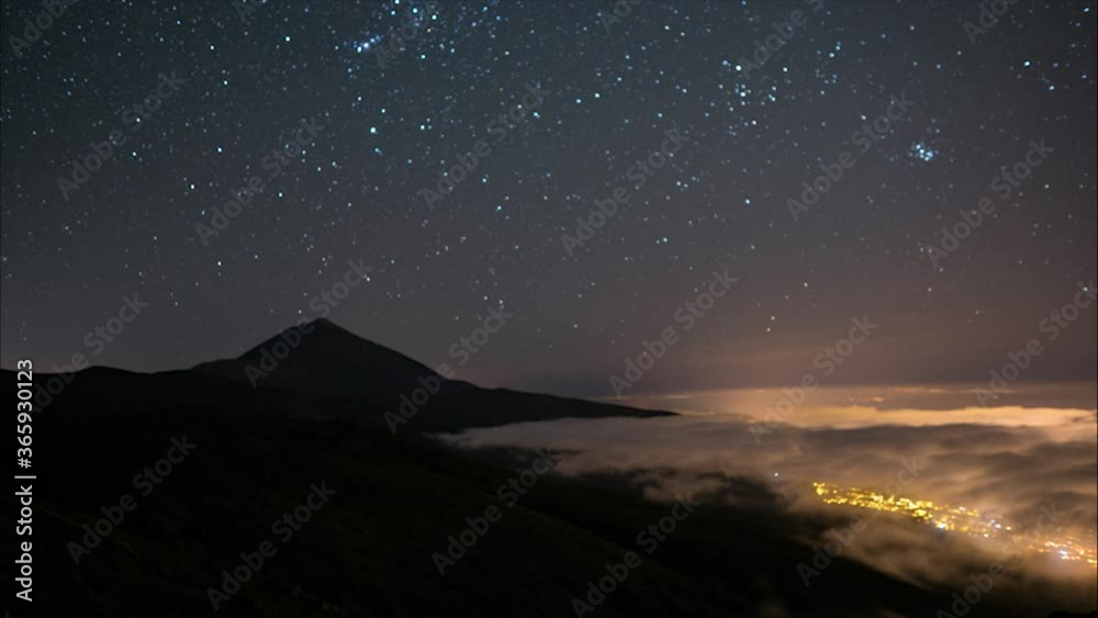 Amazing high altitude night time lapse of Mount Teide, clear starry sky and clouds below, lighted by city in valley. Tenerife, Canary Islands, Spain.
Amazing high altitude night time lapse of Mount Teide, clear starry sky and clouds below, lighted by city in valley. Tenerife, Canary Islands, Spain.