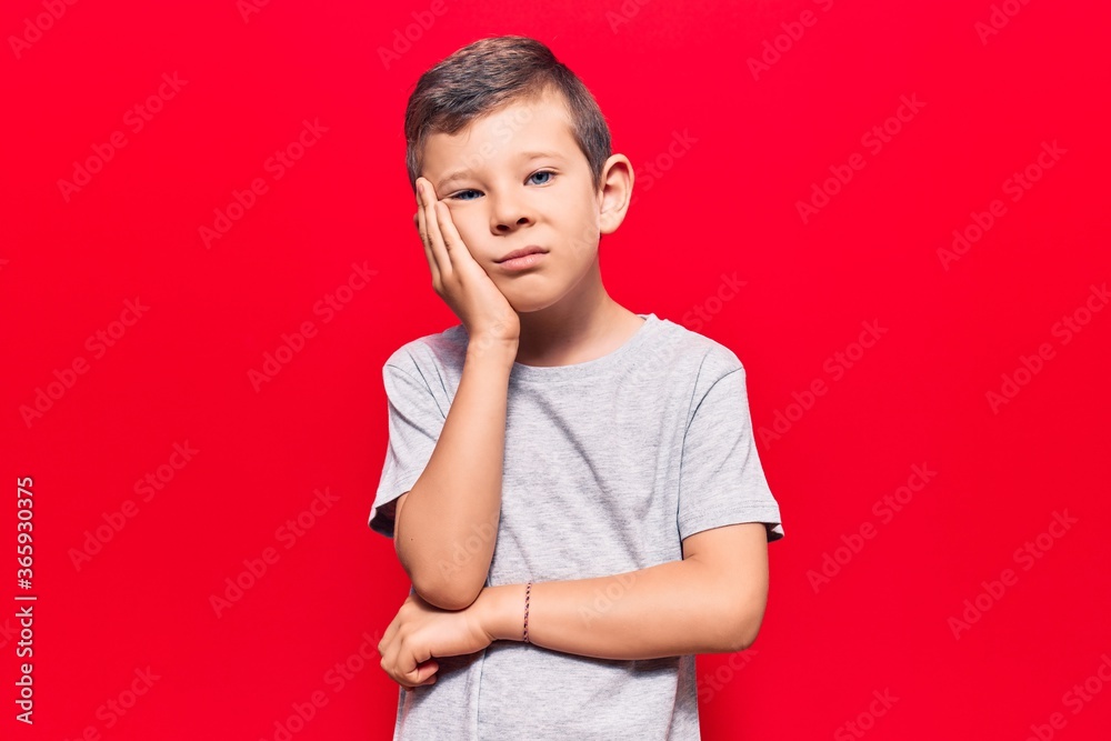 Cute blond kid wearing casual clothes thinking looking tired and bored with depression problems with crossed arms. Cute blond kid wearing casual clothes thinking looking tired and bored with depression problems with crossed arms.